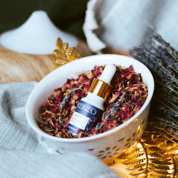 Deerieo Aurora natural facial serum is a luxury treat for the skin, here pictured on a bed of rose petals in a white porcelain bowl.