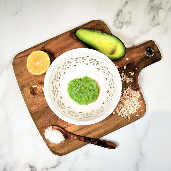 photo of a DIY ultra-rich avocado hand mask with ingredients on a wooden board