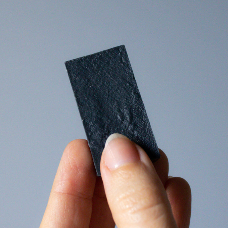 Deerieo mini Eclipse soap with detoxifying charcoal, sweet orange and spices essential oils.